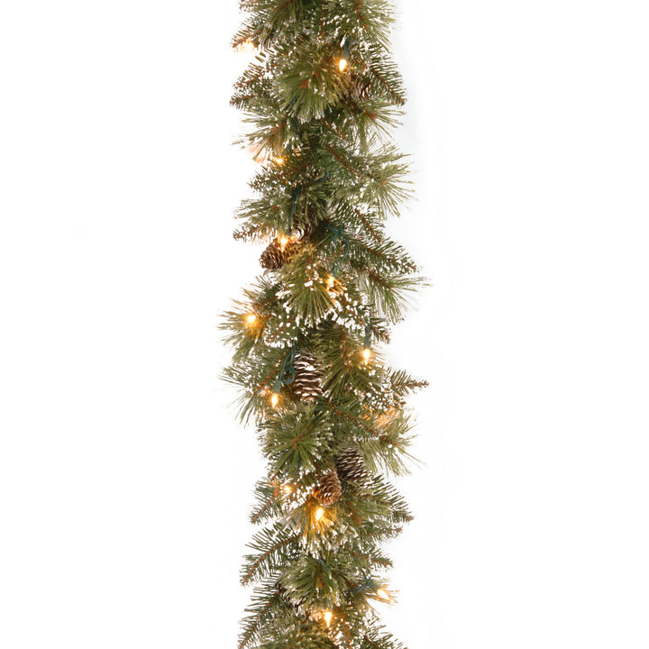 Pre-Lit Artificial Christmas Garland, Green, Glittery Bristle Pine, White Lights, Decorated with Pine Cones, Battery Operated, Christmas Collection, 6 Feet