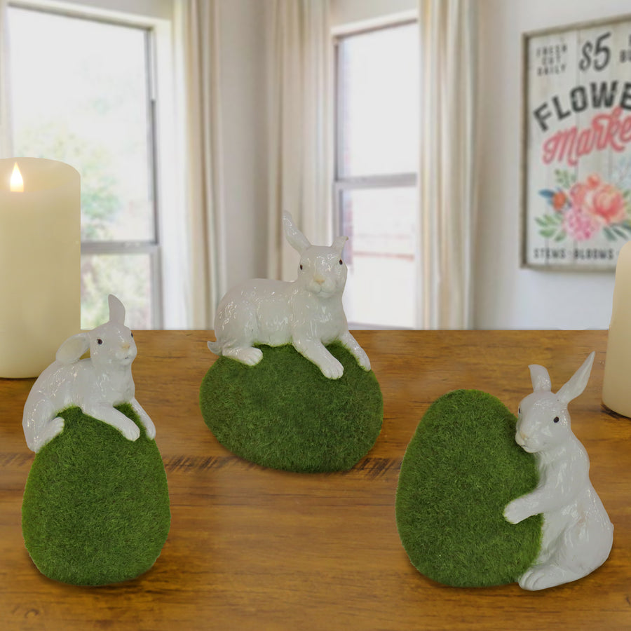 7 in. White Easter Rabbit Figures on Green Moss Covered Eggs, Set of 3