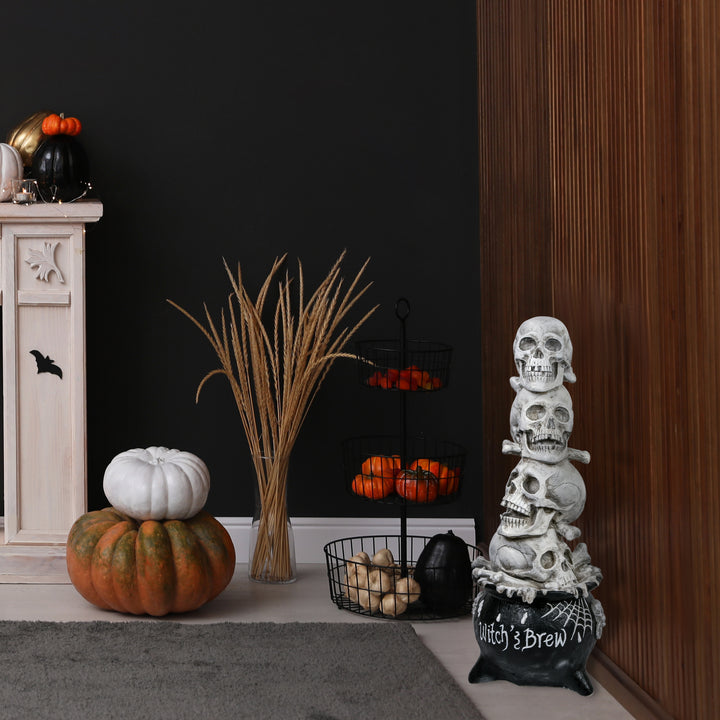 Halloween Tabletop Decoration, White, Stacked Skulls in a Cauldron, 38 Inches