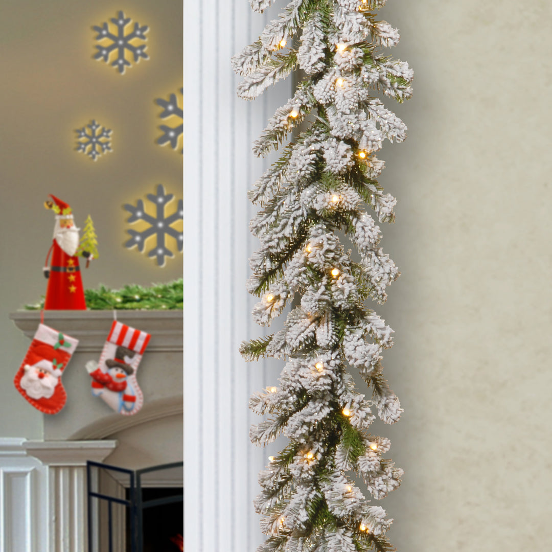 National Tree Company Pre Lit Artificial Garland, Snowy Sheffield, Green, Frosted, Decorated with Multifunctional Twinkling LED Lights, Plug In, Christmas Collection, 9 Feet