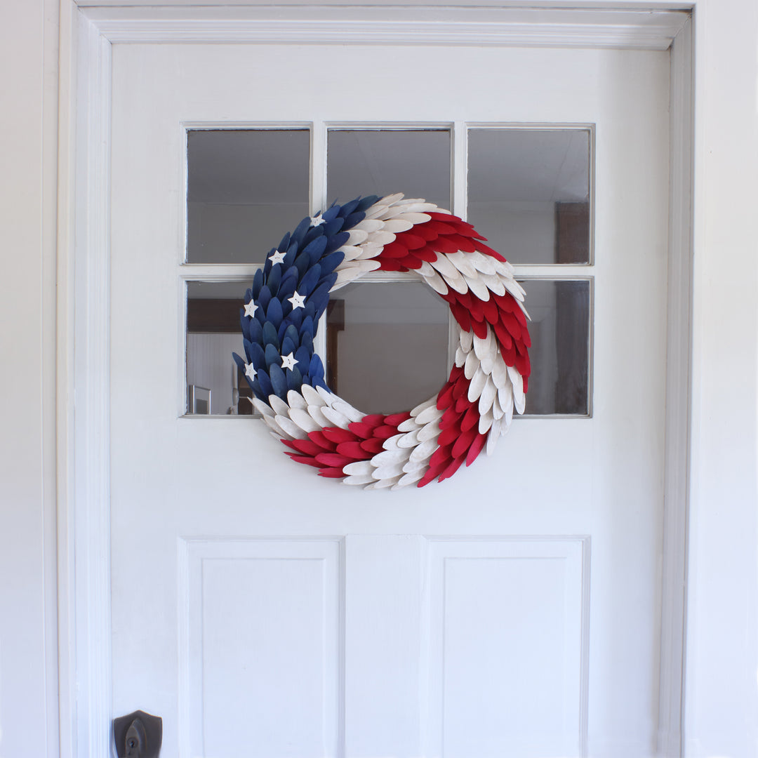 Patriotic Artificial Hanging Wreath Foam Base Decorated with Red White and Blue Wooden Feathers Stars 4th of July Collection 18 Inches