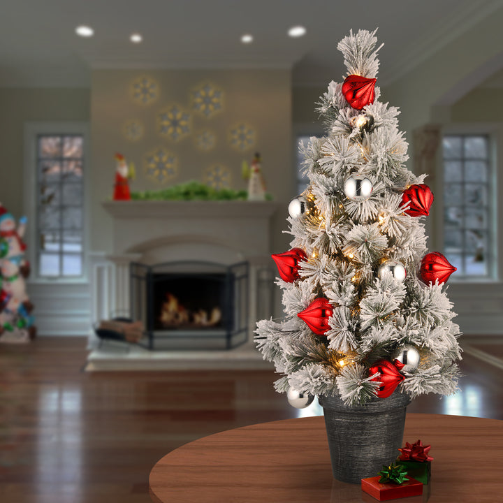 Pre-Lit Artificial Christmas Tree, Green, Snowy Bristle Pine, White LED Lights, Decorated with Pine Cones, Ball Ornaments, Includes Pot Base, Battery Operated, 24 Inches