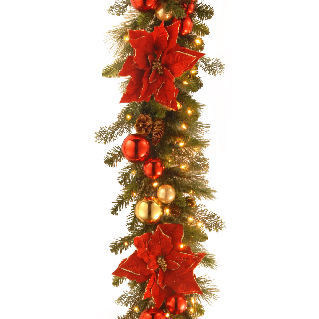 National Tree Company Pre-Lit Artificial Christmas Garland, Green, Evergreen, White Lights, Decorated With Pine Cones, Ball Ornaments, Poinsettia Flowers, Plug In, Christmas Collection, 9 Feet