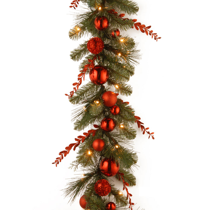 National Tree Company Pre-Lit Artificial Christmas Garland, Green, Evergreen, White Lights, Decorated With  Glittered Stems, Ball Ornaments, Battery Powered, Christmas Collection, 9 Feet